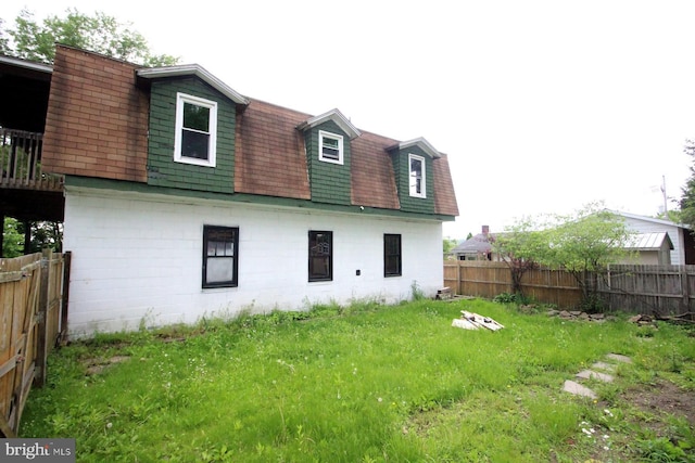 538 N 11th St, Philipsburg, PA 16866 - back of property with a fenced backyard, a shingled roof, and mansard roof