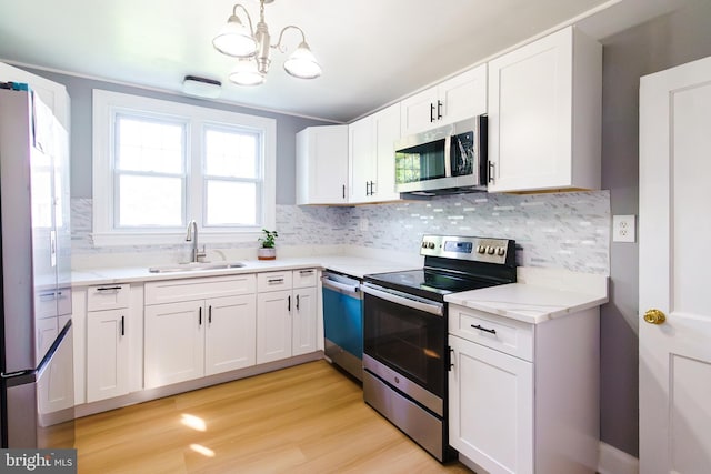 6 Carroll Rd, Catonsville, MD 21228 - kitchen featuring appliances with stainless steel finishes, a chandelier, and backsplash