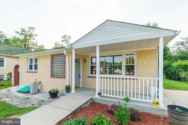 6 Carroll Rd, Catonsville, MD 21228 - view of front facade featuring covered porch and stucco siding