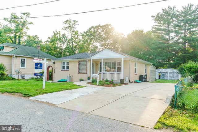 6 Carroll Rd, Catonsville, MD 21228 - view of front of home with a porch, stucco siding, and concrete driveway
