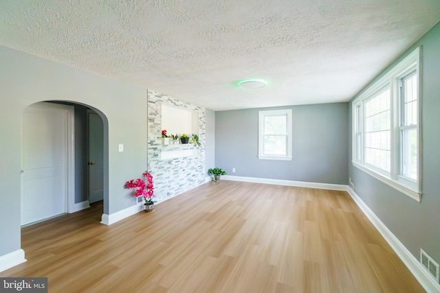 6 Carroll Rd, Catonsville, MD 21228 - spare room featuring arched walkways, a textured ceiling, and light wood finished floors
