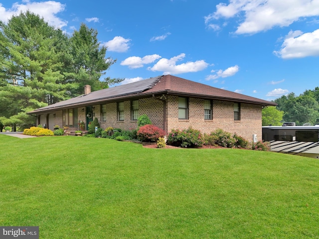 20412 Holt Cir, Hagerstown, MD 21742 - view of home's exterior with roof mounted solar panels, brick siding, a lawn, and a chimney