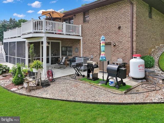 20412 Holt Cir, Hagerstown, MD 21742 - rear view of house with a balcony, brick siding, a sunroom, and a patio area