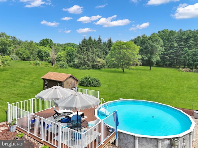 20412 Holt Cir, Hagerstown, MD 21742 - swimming pool featuring a wooden deck, a lawn, an outdoor structure, and outdoor dining space