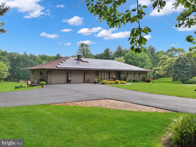 20412 Holt Cir, Hagerstown, MD 21742 - ranch-style home with brick siding, an attached garage, a front yard, roof mounted solar panels, and driveway