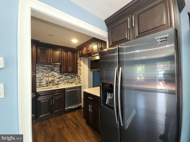 2258 Arlington Ter, Alexandria, VA 22303 - kitchen with stainless steel appliances, dark brown cabinetry, decorative backsplash, and dark wood finished floors