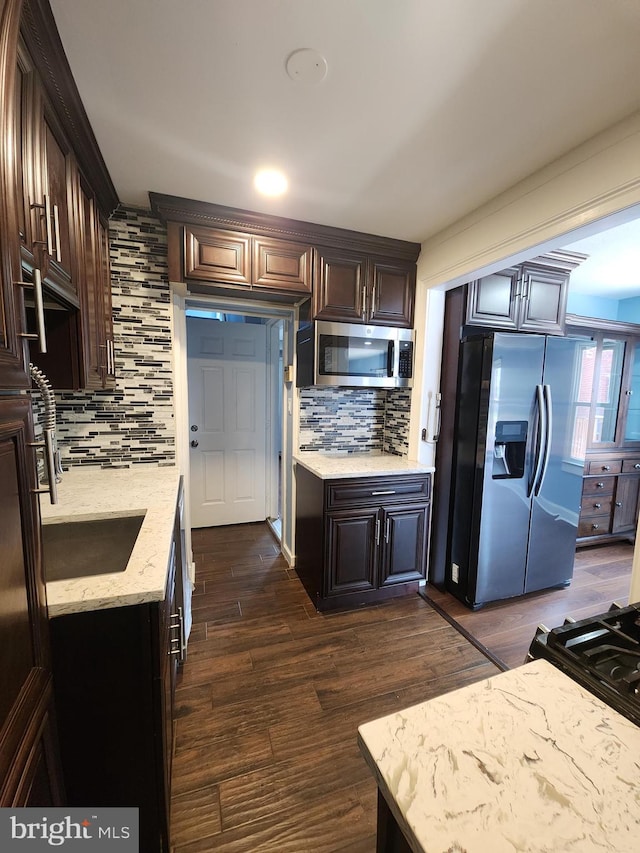 2258 Arlington Ter, Alexandria, VA 22303 - kitchen with appliances with stainless steel finishes, decorative backsplash, light stone countertops, and dark wood finished floors