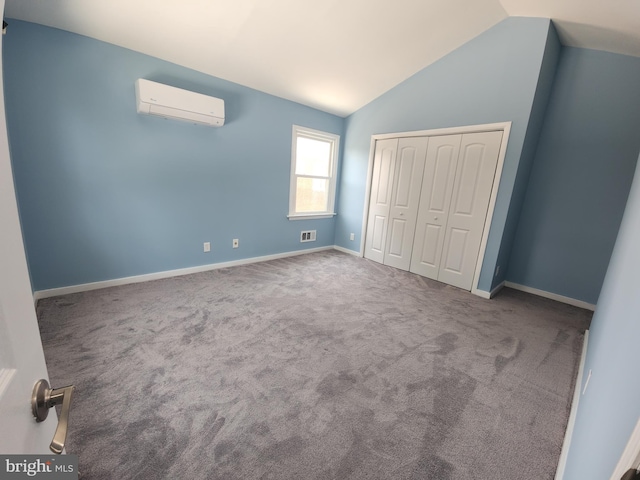 2258 Arlington Ter, Alexandria, VA 22303 - unfurnished bedroom with a wall unit AC, vaulted ceiling, carpet, and a closet