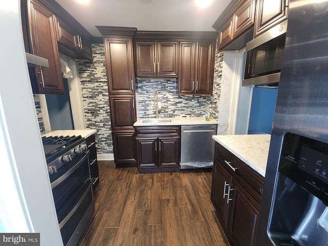 2258 Arlington Ter, Alexandria, VA 22303 - kitchen featuring stainless steel appliances, tasteful backsplash, dark wood-style flooring, and dark brown cabinets
