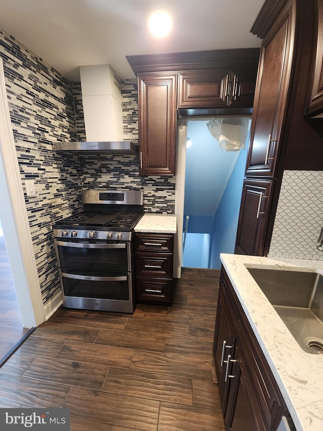 2258 Arlington Ter, Alexandria, VA 22303 - kitchen with double oven range, wall chimney exhaust hood, dark wood finished floors, light stone counters, and dark brown cabinets