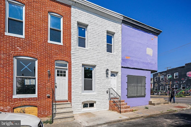 244 N Rose St, Baltimore, MD 21224 - townhome / multi-family property featuring entry steps and stone siding