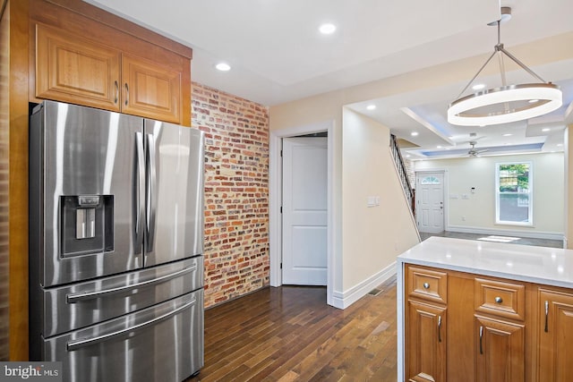 244 N Rose St, Baltimore, MD 21224 - kitchen with stainless steel fridge, brick wall, dark wood-type flooring, light countertops, and a chandelier