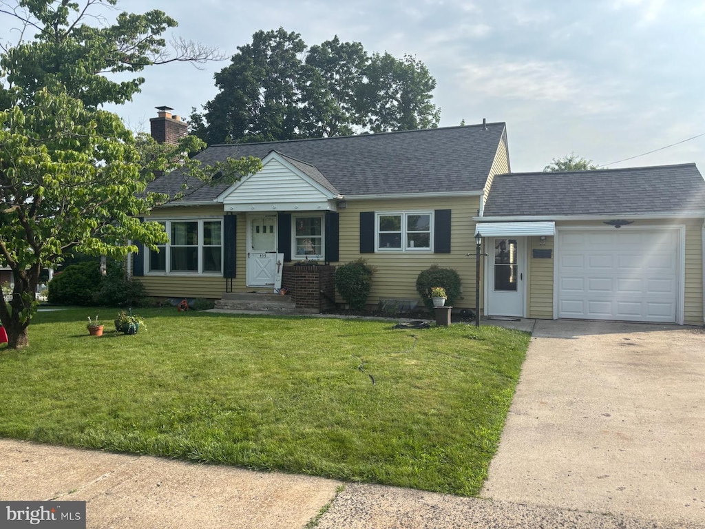 459 S 5th Ave, Royersford, PA 19468 - view of front of house featuring an attached garage, driveway, a front lawn, a chimney, and a shingled roof