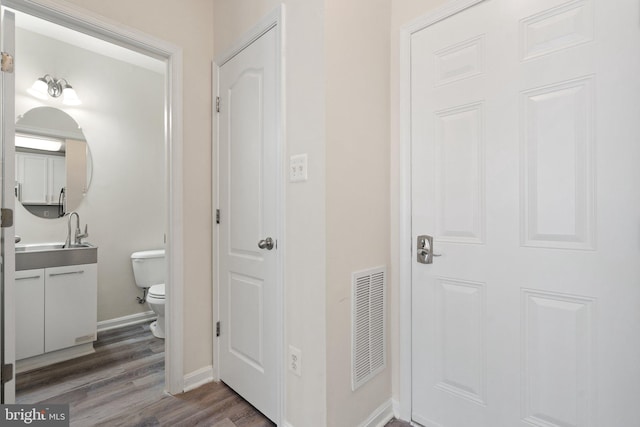 19278 Harlow Sq, Leesburg, VA 20176 - hall featuring a sink and wood finished floors