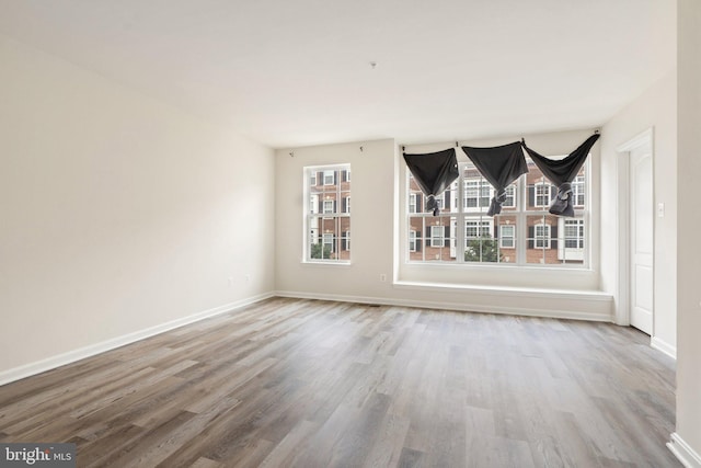 19278 Harlow Sq, Leesburg, VA 20176 - unfurnished living room featuring wood finished floors and baseboards
