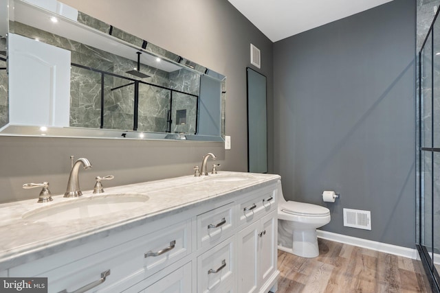 19278 Harlow Sq, Leesburg, VA 20176 - full bath with a marble finish shower, double vanity, and wood finished floors