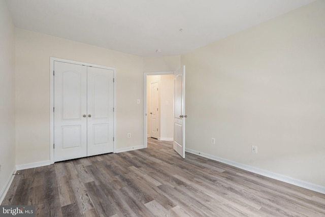 19278 Harlow Sq, Leesburg, VA 20176 - unfurnished bedroom featuring wood finished floors and a closet