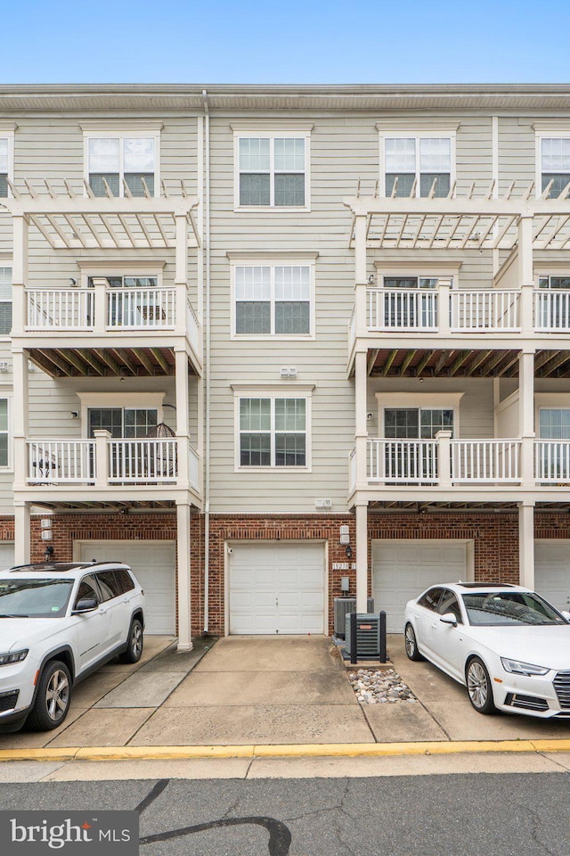 19278 Harlow Sq, Leesburg, VA 20176 - view of front of property featuring driveway, an attached garage, and brick siding