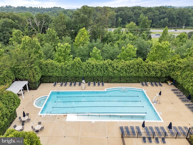 19278 Harlow Sq, Leesburg, VA 20176 - community pool with a wooded view and a patio area