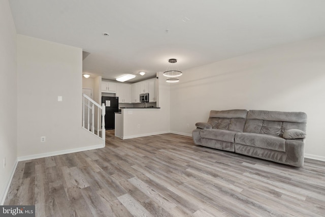 19278 Harlow Sq, Leesburg, VA 20176 - living room featuring light wood-type flooring and stairs