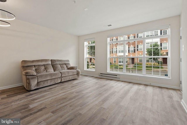 19278 Harlow Sq, Leesburg, VA 20176 - living room with wood finished floors and baseboard heating