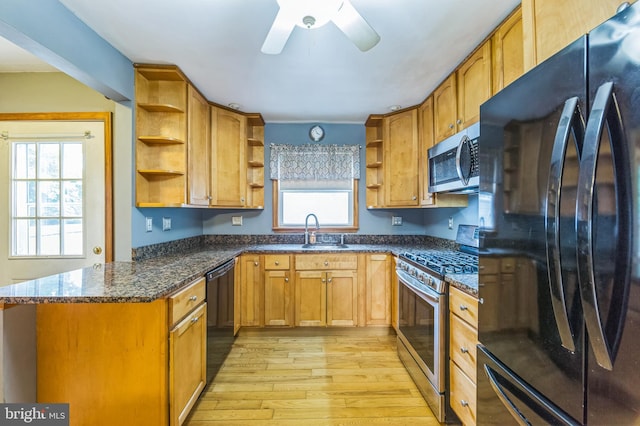 739 Brooke Cir, Morton, PA 19070 - kitchen featuring black appliances, open shelves, light wood finished floors, ceiling fan, and dark stone counters