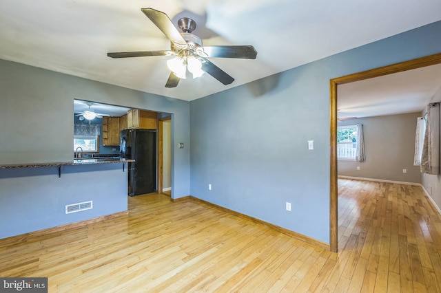 739 Brooke Cir, Morton, PA 19070 - kitchen with freestanding refrigerator, ceiling fan, light wood finished floors, and plenty of natural light