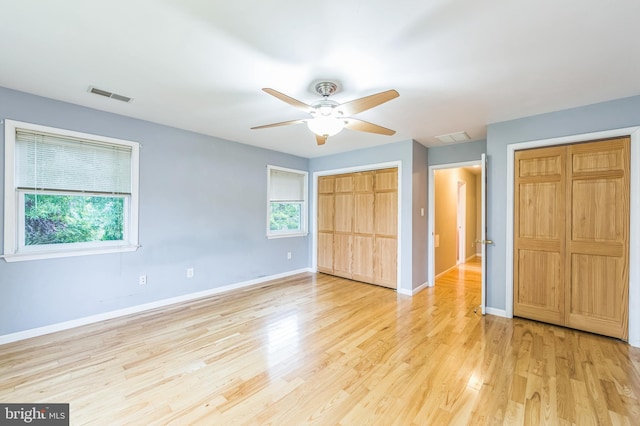 739 Brooke Cir, Morton, PA 19070 - unfurnished bedroom featuring multiple closets, light wood finished floors, and ceiling fan