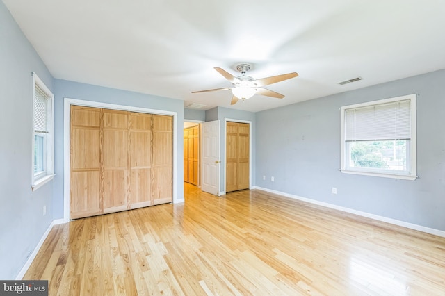 739 Brooke Cir, Morton, PA 19070 - unfurnished bedroom with light wood-style floors, two closets, and a ceiling fan