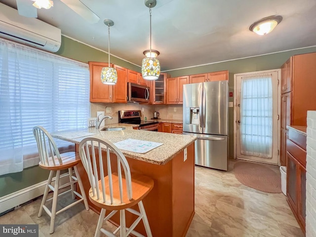 237 Lakeside Dr Unit N, Levittown, PA 19054 - kitchen with stainless steel appliances, an AC wall unit, a peninsula, light countertops, and a breakfast bar area