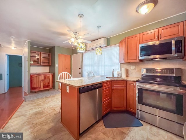 237 Lakeside Dr Unit N, Levittown, PA 19054 - kitchen featuring appliances with stainless steel finishes, a peninsula, an AC wall unit, a ceiling fan, and light stone countertops