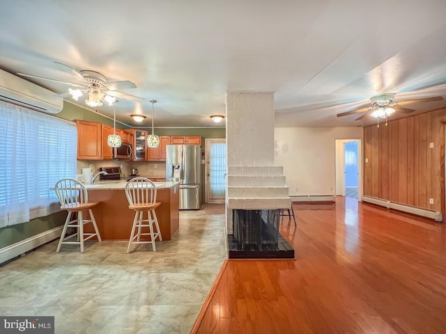 237 Lakeside Dr Unit N, Levittown, PA 19054 - kitchen featuring appliances with stainless steel finishes, a ceiling fan, baseboard heating, and a peninsula