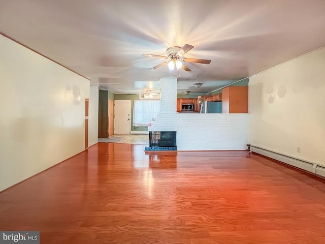237 Lakeside Dr Unit N, Levittown, PA 19054 - unfurnished living room with a ceiling fan, light wood-style floors, and a brick fireplace