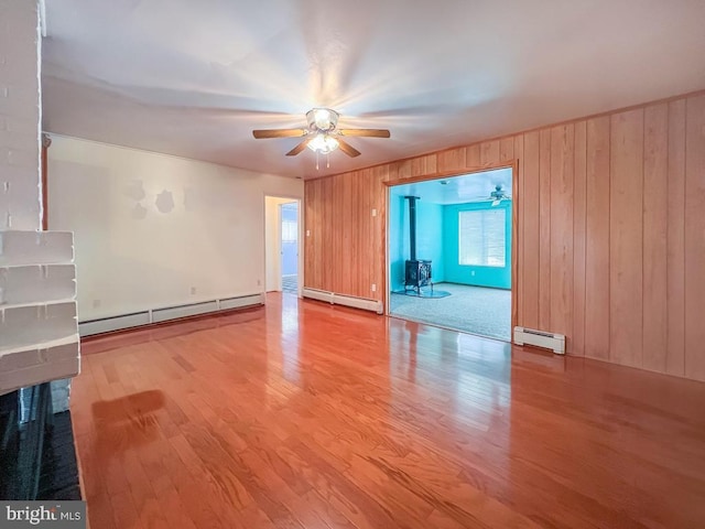 237 Lakeside Dr Unit N, Levittown, PA 19054 - unfurnished room with baseboard heating, a ceiling fan, wood finished floors, and wooden walls