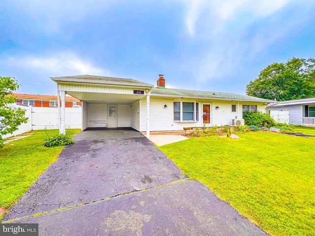 237 Lakeside Dr Unit N, Levittown, PA 19054 - view of front of house with a chimney, asphalt driveway, and a carport