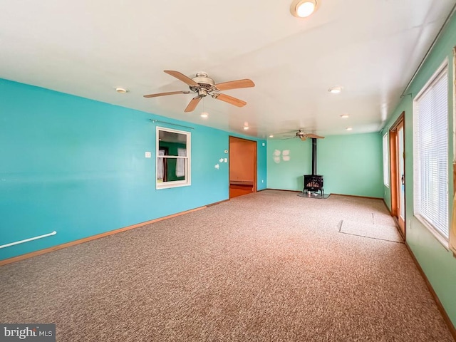 237 Lakeside Dr Unit N, Levittown, PA 19054 - empty room featuring a wood stove, carpet floors, a ceiling fan, a baseboard radiator, and recessed lighting