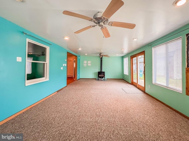 237 Lakeside Dr Unit N, Levittown, PA 19054 - spare room featuring a wood stove, carpet, recessed lighting, and ceiling fan