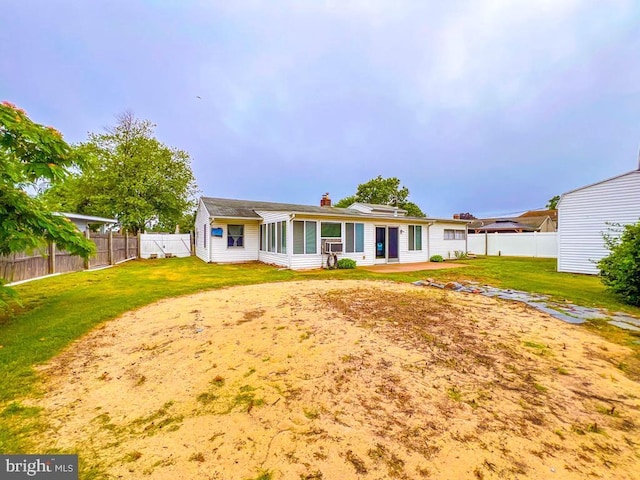237 Lakeside Dr Unit N, Levittown, PA 19054 - rear view of house with a fenced backyard, a chimney, and a sunroom