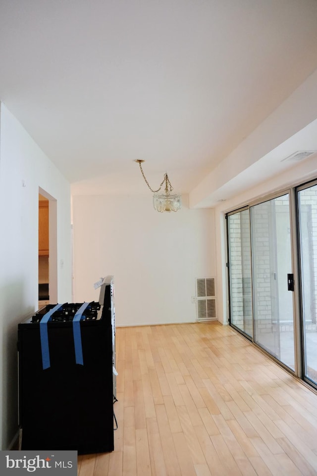 12213 Braxfield Ct Unit 15, Rockville, MD 20852 - unfurnished living room with light wood-style flooring and a chandelier