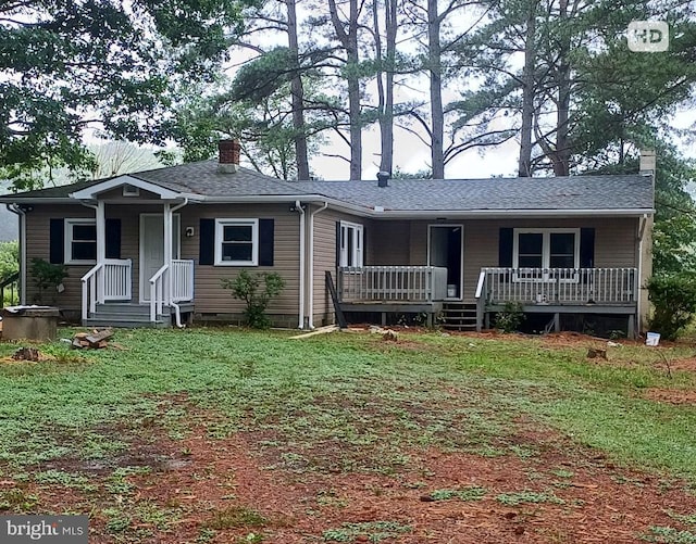 1171 Jones Creek Rd, Warsaw, VA 22572 - ranch-style home featuring covered porch, a chimney, a front lawn, and roof with shingles