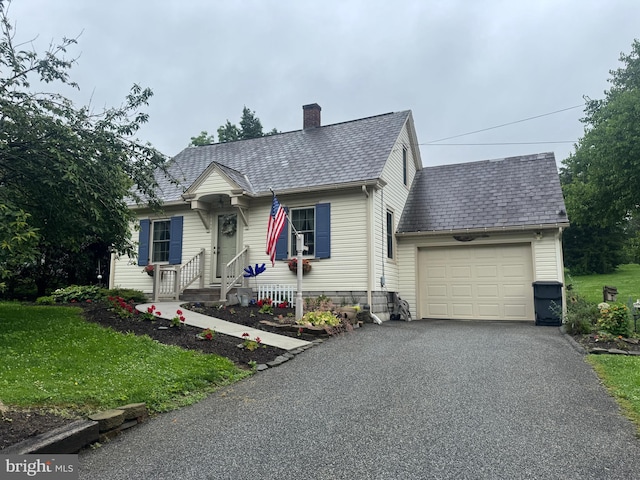 18 Benedict Rd, Lancaster, PA 17603 - view of front of home featuring an attached garage, a chimney, driveway, and a front yard