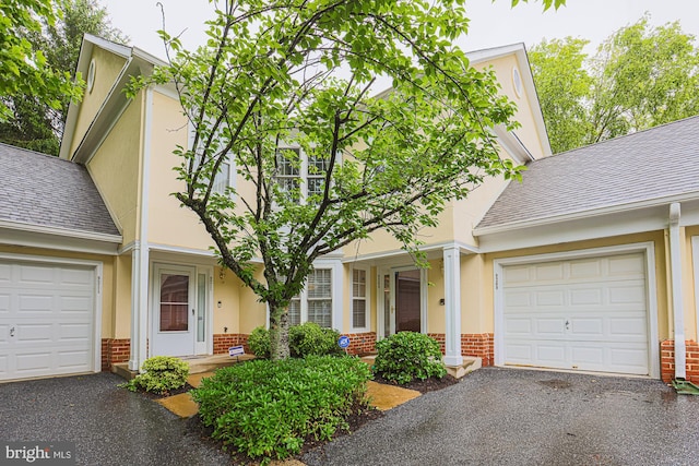 9209 Howard Square Dr Unit 9209, Pikesville, MD 21208 - view of front of home featuring brick siding, asphalt driveway, and a garage