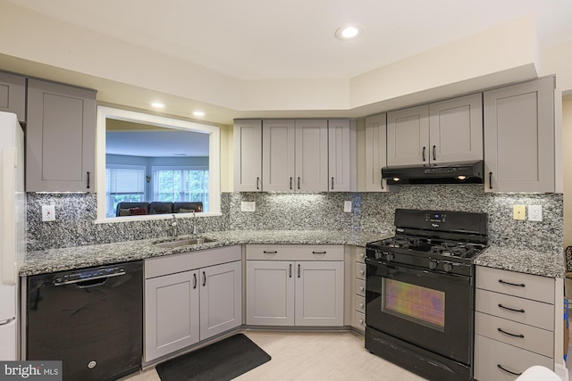 9209 Howard Square Dr Unit 9209, Pikesville, MD 21208 - kitchen with black appliances, under cabinet range hood, gray cabinets, light stone countertops, and decorative backsplash