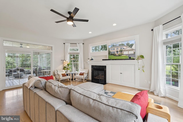 18416 Mill Run Ct, Leesburg, VA 20176 - living room with healthy amount of natural light, light wood-type flooring, a fireplace with flush hearth, and recessed lighting