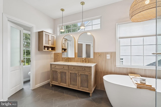 18416 Mill Run Ct, Leesburg, VA 20176 - full bath featuring double vanity, a freestanding bath, a wainscoted wall, and tile patterned flooring