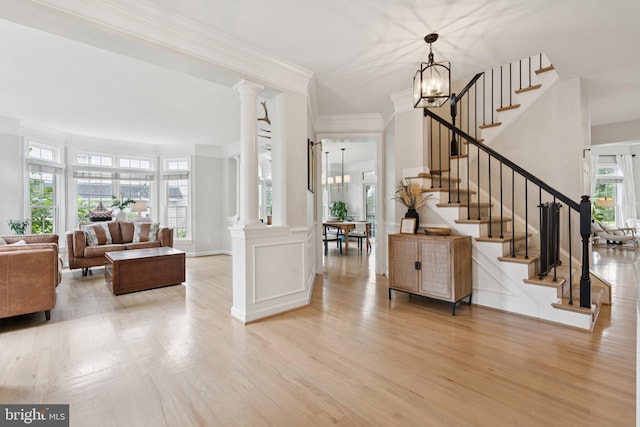 18416 Mill Run Ct, Leesburg, VA 20176 - foyer entrance featuring ornamental molding, light wood finished floors, stairs, a chandelier, and ornate columns