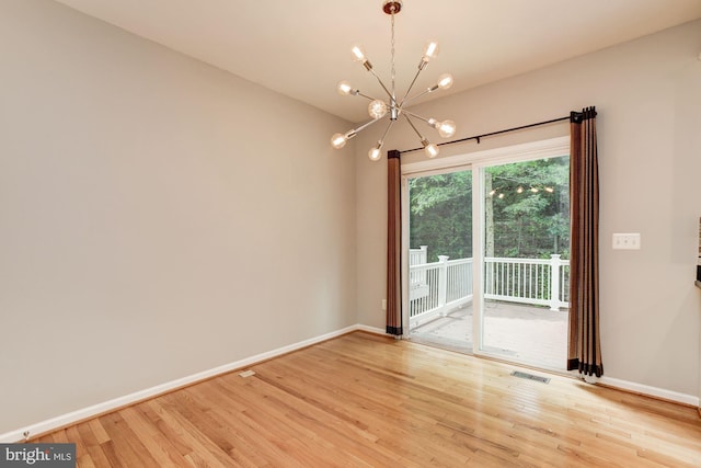 7041 Water Oak Rd Unit 42, Elkridge, MD 21075 - spare room featuring a chandelier and wood finished floors
