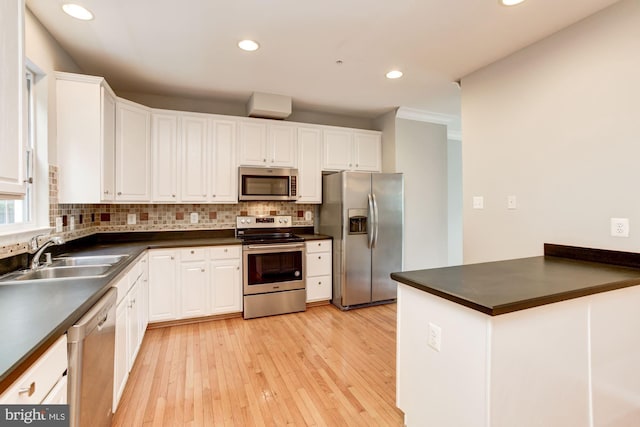 7041 Water Oak Rd Unit 42, Elkridge, MD 21075 - kitchen featuring appliances with stainless steel finishes, dark countertops, decorative backsplash, white cabinetry, and recessed lighting