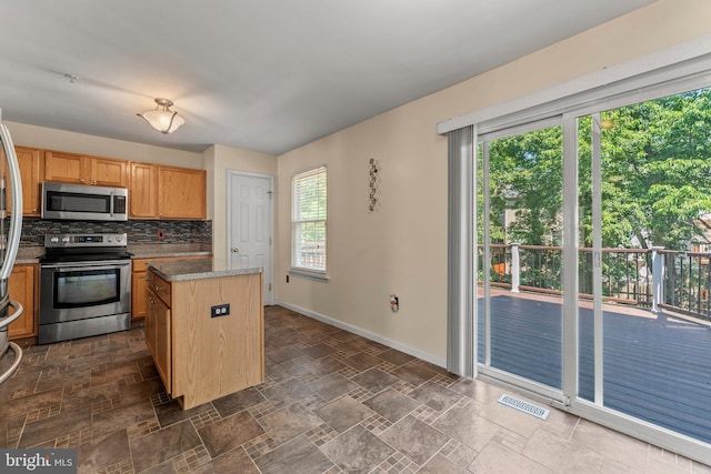 5522 Trout Run Rd, Clinton, MD 20735 - kitchen featuring stainless steel appliances, a kitchen island, healthy amount of natural light, and dark stone finish flooring