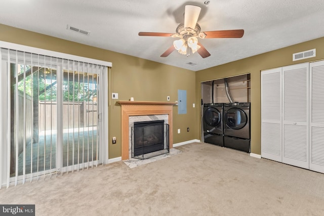 5522 Trout Run Rd, Clinton, MD 20735 - unfurnished living room featuring washing machine and clothes dryer, electric panel, carpet flooring, a high end fireplace, and ceiling fan